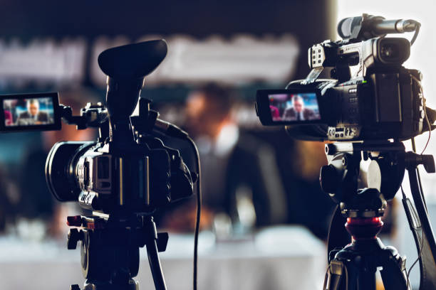 professional digital camera recording presentation a a blurred speaker wearing suit