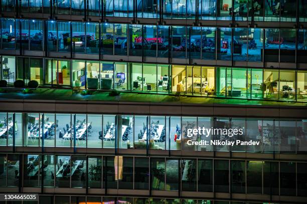 close up of illuminated modern office building during night hours in london city, uk - creative stock photo - full transparency stock pictures, royalty-free photos & images