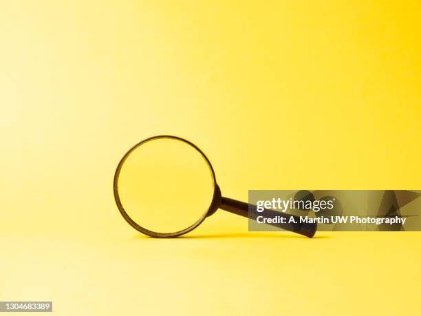 magnifying glass on yellow background. search and investigation concept. - loupe bildbanksfoton och bilder