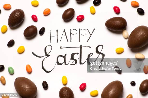 happy easter card with chocolate easter eggs - easter egg white background stock pictures, royalty-free photos & images