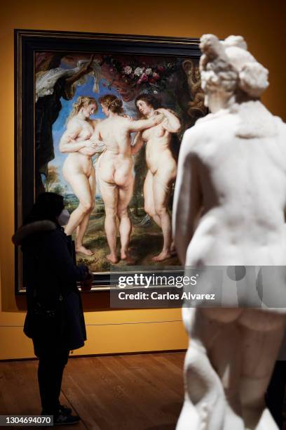 Woman observes Rubens painting 'The Three Graces' belonging to the exhibition 'Mythological Passions' at the Prado Museum on March 01, 2021 in...