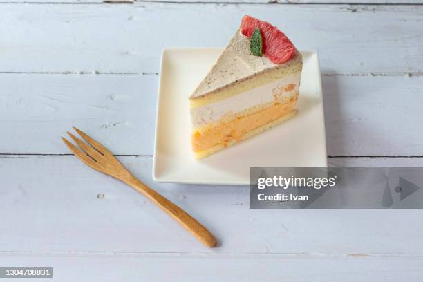 creamy sliced fruit grapefruit cake on white plate - whip cream cake fotografías e imágenes de stock