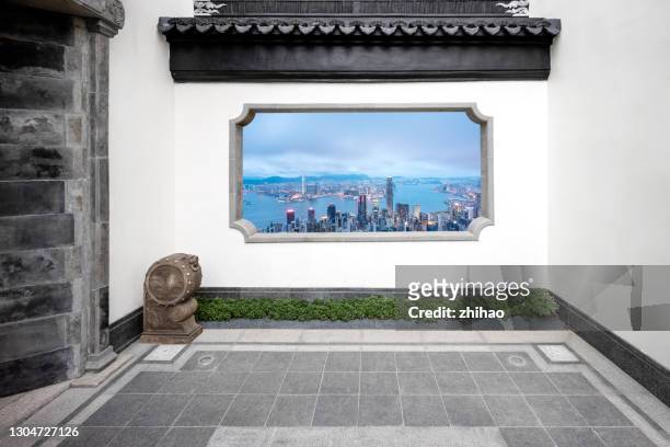 see the city skyline through the windows of a traditional chinese courtyard - heritage hall stock pictures, royalty-free photos & images