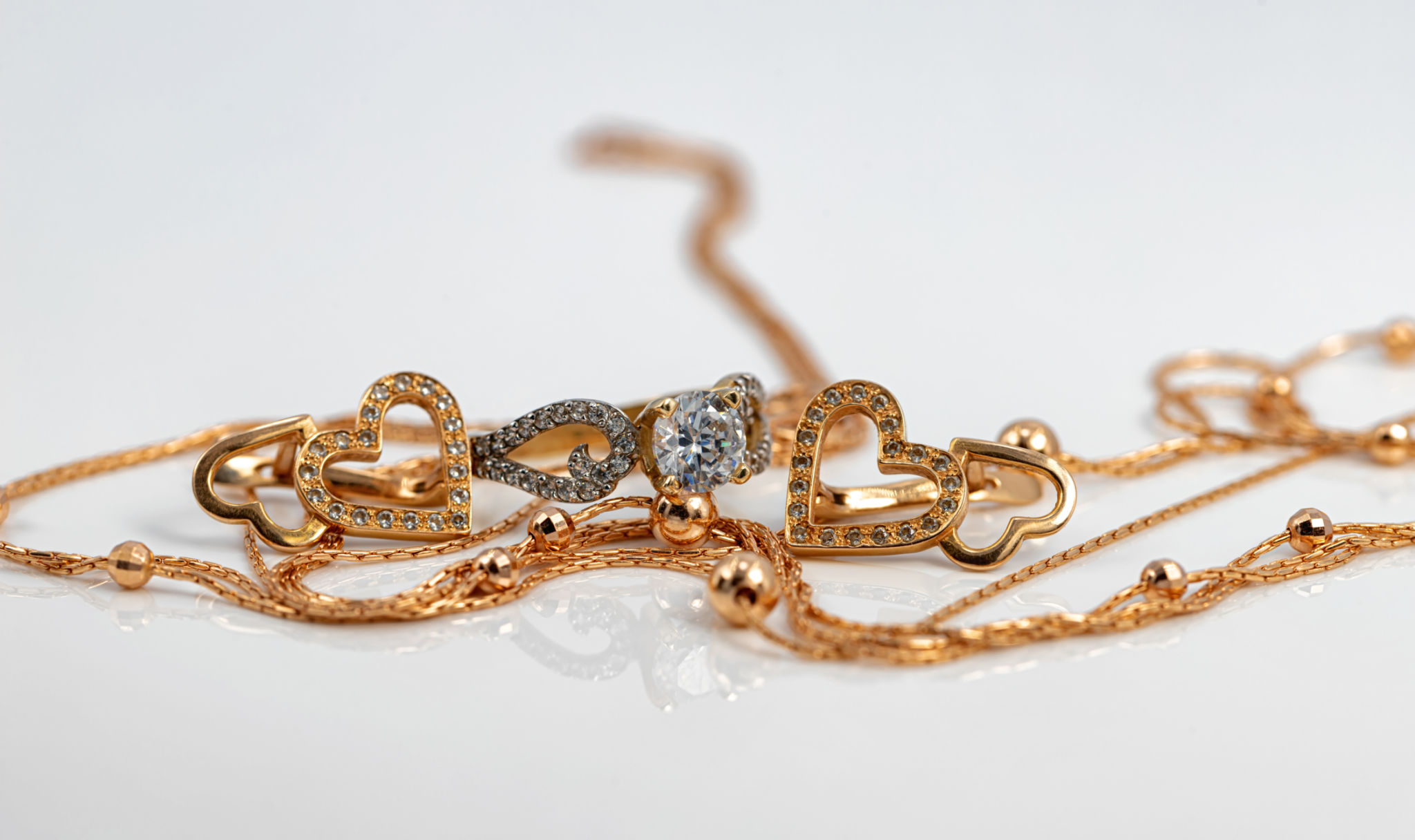 Set of gold jewelry: a chain with a pendant, earrings and a ring with Topaz Set of gold jewelry: a chain with a pendant, earrings and a ring with Topaz