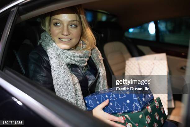 driving in a taxi with some gifts - christmas driving stock pictures, royalty-free photos & images