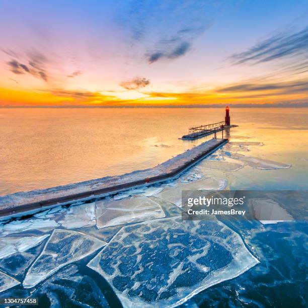 scenic winter aerial view of lighthouse before the dawn sky - lake michigan stock pictures, royalty-free photos & images