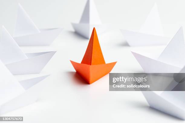 be different - origami boat stock pictures, royalty-free photos & images