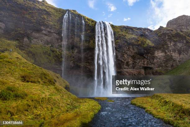 seljalandsfoss waterfall in the midday sun - waterfall stock pictures, royalty-free photos & images