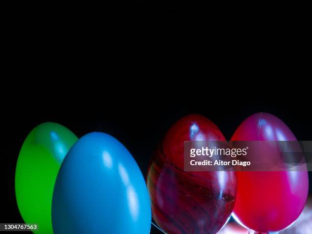 three easter eggs against black background. - easter fantasy stockfoto's en -beelden