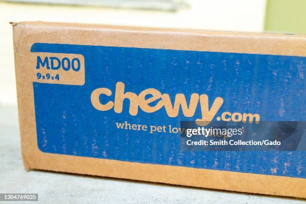 Angled close up of a box from pet-product online retailer Chewy, resting on a light-colored countertop, February 17, 2021.