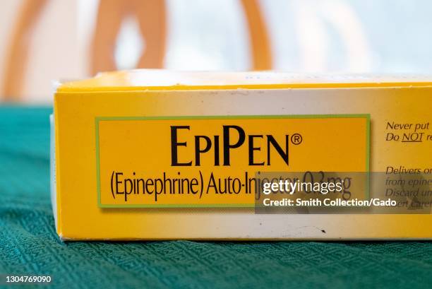 Close-up of an "EpiPen" logo on a yellow epinephrine autoinjector box, February 17, 2021.
