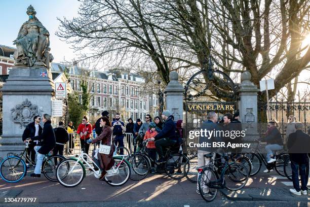 People are seen at the closed entry gates to the Vondelpark on February 2021, in Amsterdam, Netherlands. The park has been closed by local...
