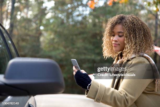 lovely african american insurance adjuster inspecting damage to vehicle. - car accident report stock pictures, royalty-free photos & images