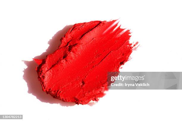 red textured smear of lipstick on white background. - lippenstift stock-fotos und bilder