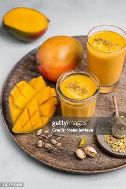 mango lassi drankje met pistachenoten en kardemom zelfgemaakt naar indiaas recept - mango juice stockfoto's en -beelden