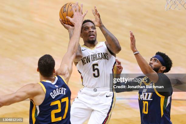 Eric Bledsoe of the New Orleans Pelicans shoots against Rudy Gobert and Mike Conley of the Utah Jazz during the first half at the Smoothie King...