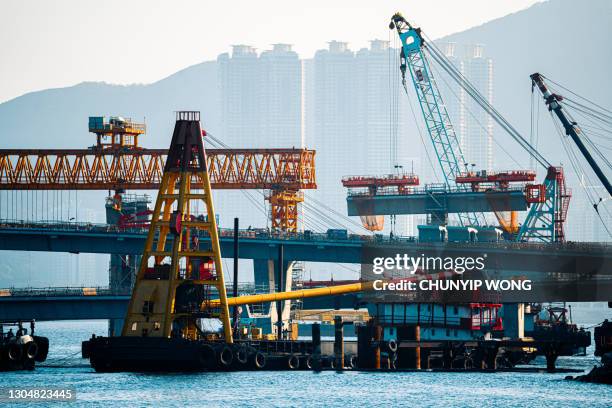 construction crane at barge in tseung kwan o, hong kong - large construction site stock pictures, royalty-free photos & images