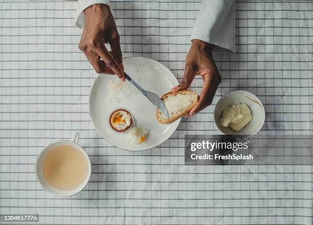 a woman having a breakfast - bread butter stock pictures, royalty-free photos & images
