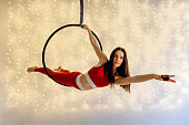 Aerial dance performance with an aerial hoop against the beautiful illuminated background