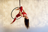 Aerial dance with an aerial hoop against the beautiful illuminated background