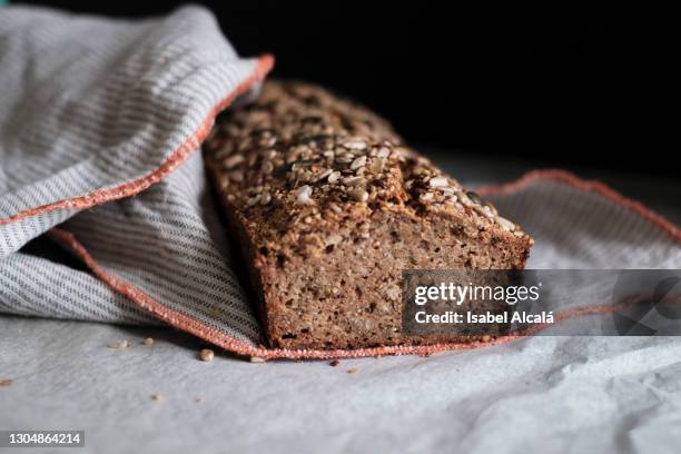 homemade, integral bread loaf with pipe seeds on top on top of baking p - granary stock pictures, royalty-free photos & images