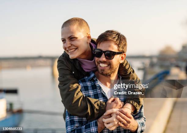 krebskranke frau und ihr partner zu fuß in der nähe des flussufers an sonnigen tag - cancer stock-fotos und bilder