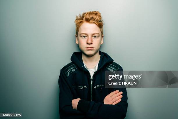 young boy standing confidently with arms crossed - boy portrait studio stock pictures, royalty-free photos & images