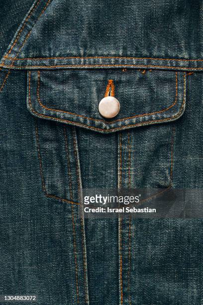 close up of a top quality of the detail of a blue denim jacket pocket. texture concept - jean jacket stock pictures, royalty-free photos & images