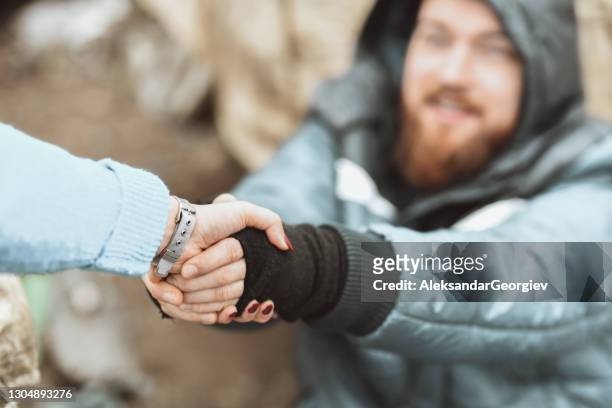 offer a helping hand to the poor and homeless - beggar stock pictures, royalty-free photos & images