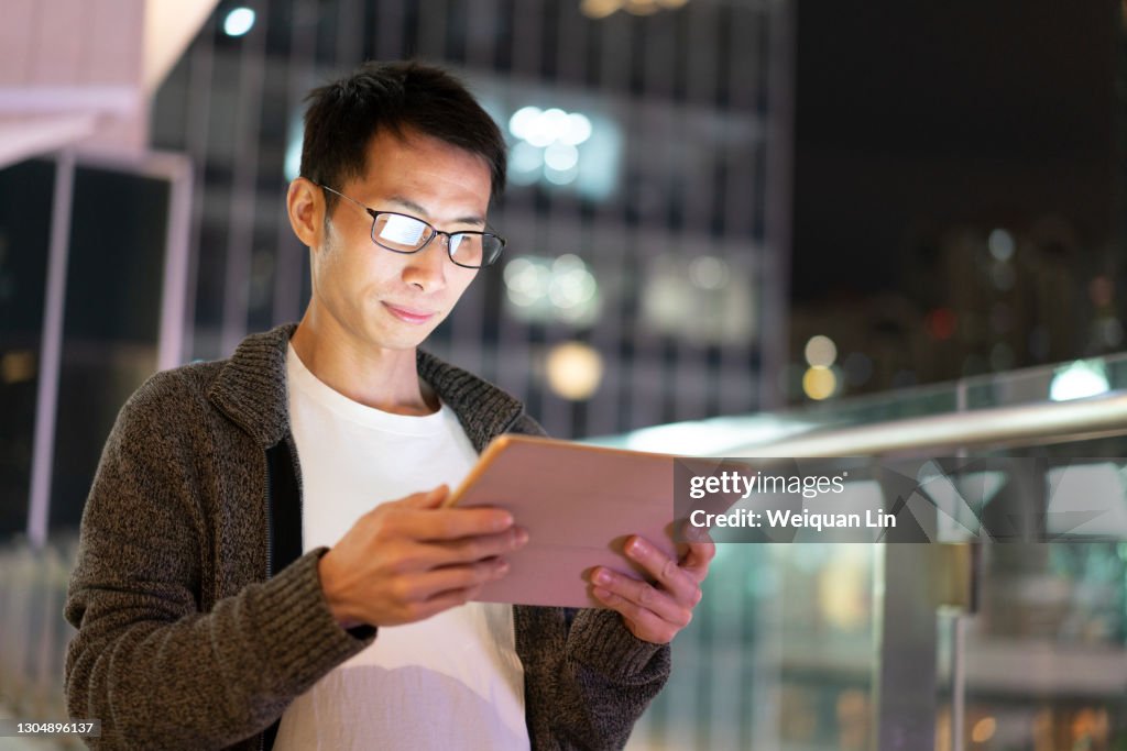 Japanese Man Using Computer Asian Man Using Tablet Computer Outdoors At Night High-Res Stock Photo ...