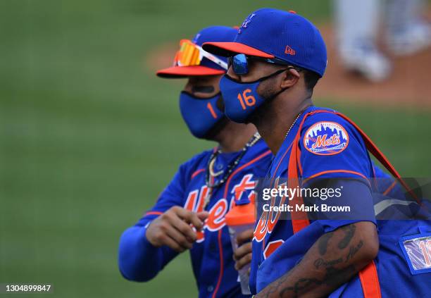 Jonathan Villar and Jose Martinez of the New York Mets head back to the clubhouse while wearing masks after the fifth inning against the Miami...