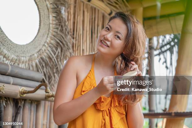 asian woman brushing her tangled hair - bristle stock pictures, royalty-free photos & images