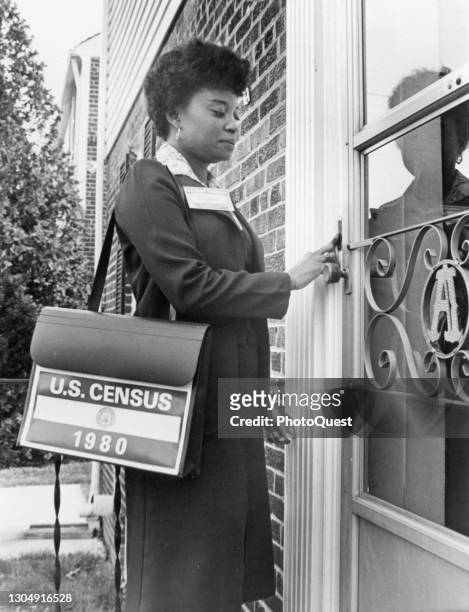 Publicity photo shows a census taker as she rings a doorbell , Washington DC, 1980.