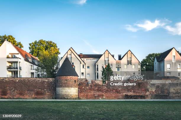 contemporary residential houses behind old surrounding wall of duisburg - duisburg stock pictures, royalty-free photos & images