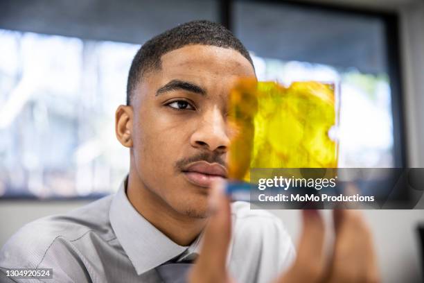 businessman examining prototype in office - intellectueel eigendom stockfoto's en -beelden