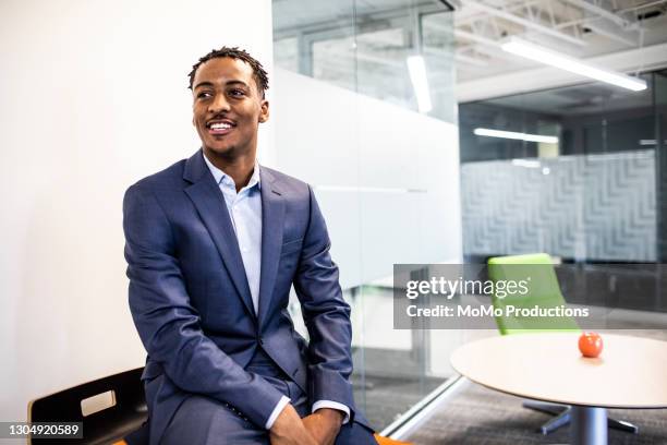 portrait of businessman in modern office - african american business man stock-fotos und bilder