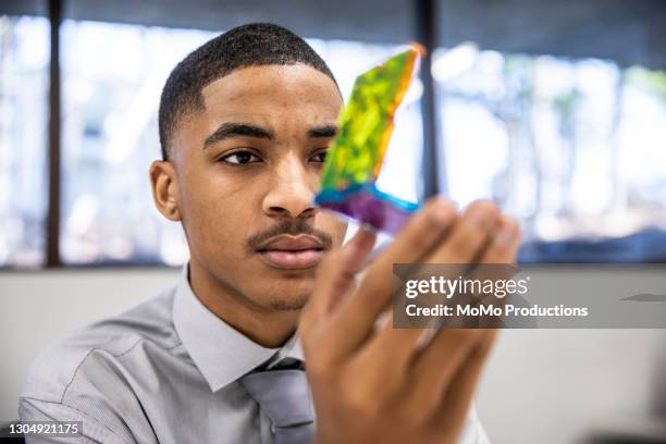 businessman examining prototype in office - prototype stock pictures, royalty-free photos & images