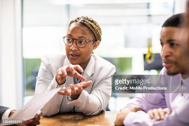 businesswoman leading office discussion - employee engagement stock pictures, royalty-free photos & images