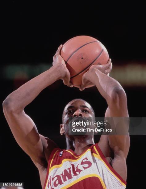 Stacey Augmon, Shooting Guard and Small Forward for the Atlanta Hawks attempts a free throw during the NBA Midwest Division basketball game against...