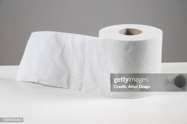 close-up of toilet paper roll on a white table. - traveler's diarrhoea stock pictures, royalty-free photos & images