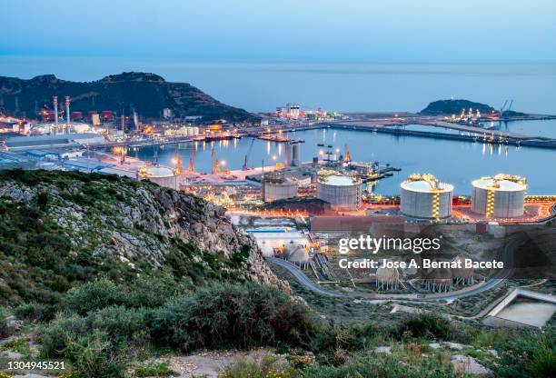 petrochemical plant and oil refinery industry by the sea at sunset. - gas plant sunset stock-fotos und bilder