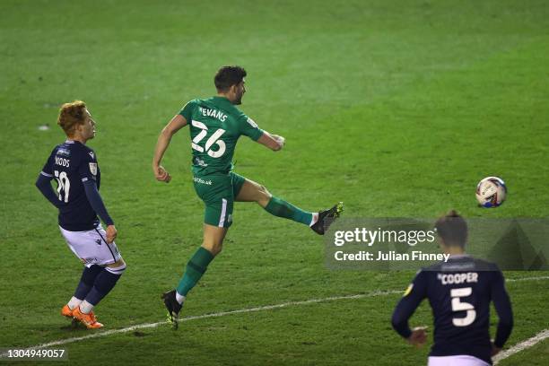 Ched Evans of Preston North End scores their sides first goal whilst under pressure from Ryan Woods of Millwall during the Sky Bet Championship match...