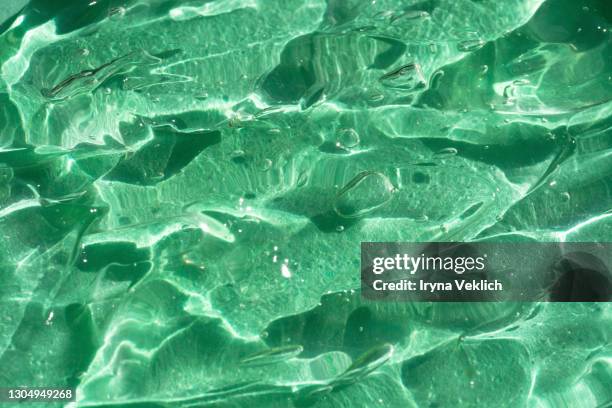 texture of water gel smudge from aloe vera, abstract background. - ミントグリーン ストックフォトと画像