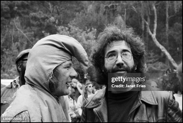 American poet and social activist Wavy Gravy and Rock musician Jerry Garcia , of the group the Grateful Dead, talk together during a concert at...