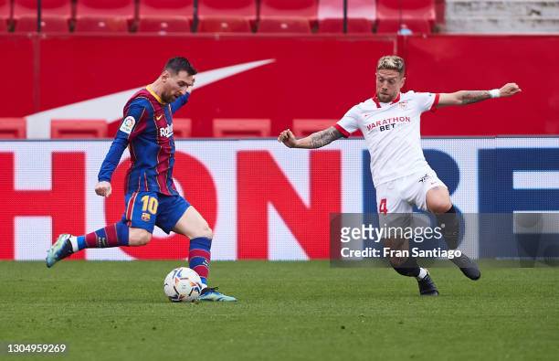 Alejandro Papu Gomez of Sevilla FC competes for the ball with Lionel Messi of FC Barcelona during the La Liga Santander match between Sevilla FC and...