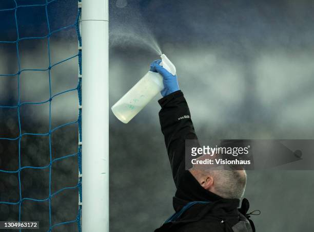The goal posts being sprayed with disinfectant before the Premier League match between Everton and Southampton at Goodison Park on March 1, 2021 in...