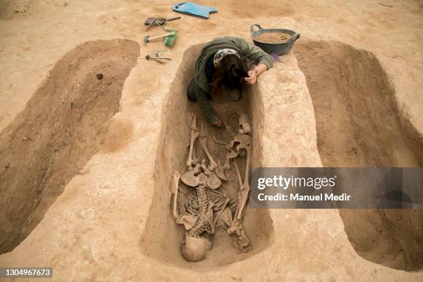 Archaeologists excavate, clean and extract skeletons found in mass graves on March 2, 2021 in Mora de Ebro, Spain. Some 62 bodies of republican...