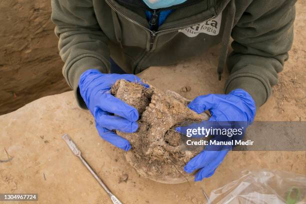 Archaeologists excavate, clean and extract skeletons found in mass graves on March 2, 2021 in Mora de Ebro, Spain. Some 62 bodies of republican...