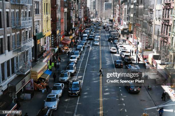 People walk through the streets of Chinatown on March 02, 2021 in New York City. Chinatown, one of Manhattan's oldest neighborhoods, has experienced...