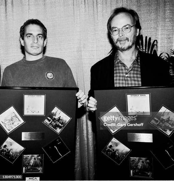 American Pop and Jazz musicians Donald Fagen and Walter Becker , both of the group Steely Dan, pose with award plaques, backstage at Brendan Byrne...